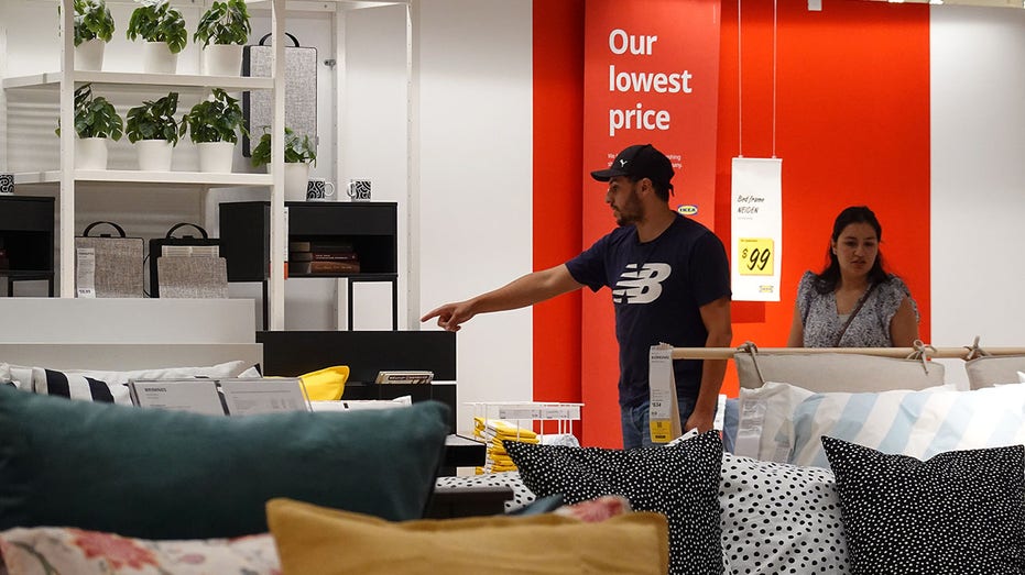 Customers shop for furniture at an IKEA store