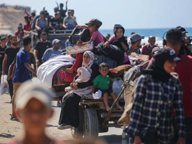 palestinians make their way along al rashid road toward gaza city from nuseirat in the central gaza strip on october 10 2025 photo afp