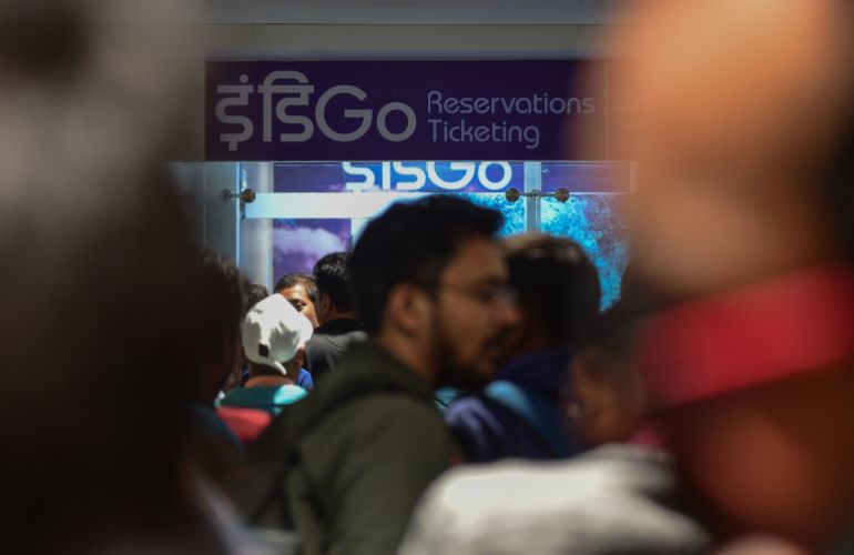 NEW DELHI, INDIA - DECEMBER 05: Passengers gather outside Indigo reservation counter inside Terminal 1 of Indira Gandhi International Airport after mass cancellation of Indigo flights on December 05, 2025 in New Delhi, India. IndiGo, India's largest airline, cancelled over 200 flights across major hubs including Delhi, Mumbai, Bengaluru and Hyderabad in early December due to the implementation of new crew duty time regulations, leaving thousands of passengers stranded and frustrating travellers with minimal prior notification. (Photo by Ritesh Shukla/Getty Images)