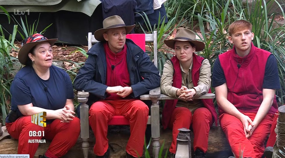 group of individuals seated in a natural setting dressed in casual outdoor attire