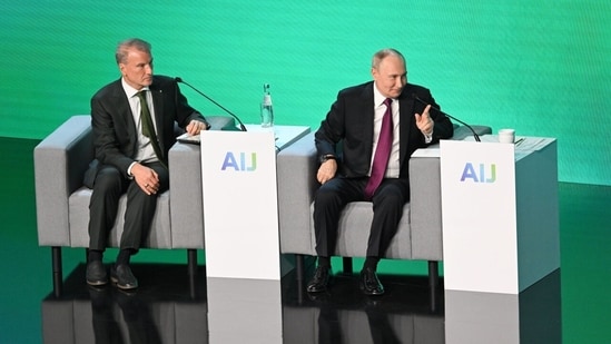 Russian President Vladimir Putin, in red tie, at an AI forum in Moscow with Sberbank CEO Herman Gref. The state-owned lender leads Russia’s AI efforts.