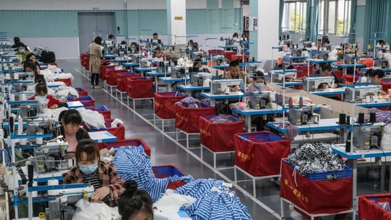 Workers sew clothes at China’s Dongguan Tingxuyuan Garment, a subcontractor for Shein, in 2023.
