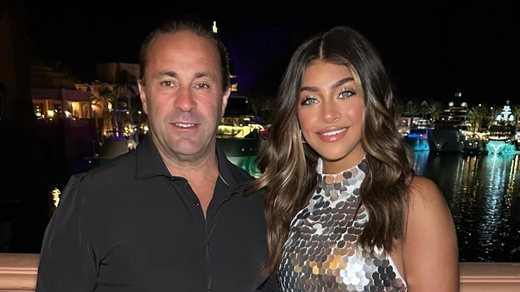 Joe Giudice and Gia Giudice smiling next to each other in front of a harbor.
