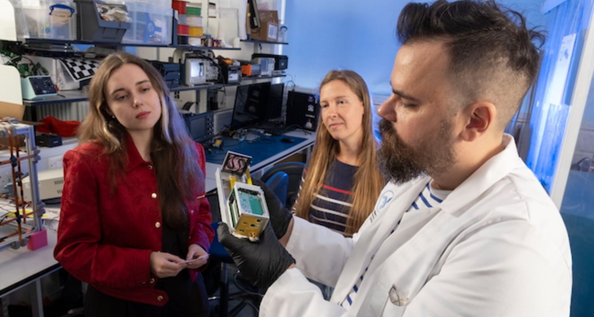 An experiment using different colored bacteria with the camera focused on a metal box containing the bacteria
