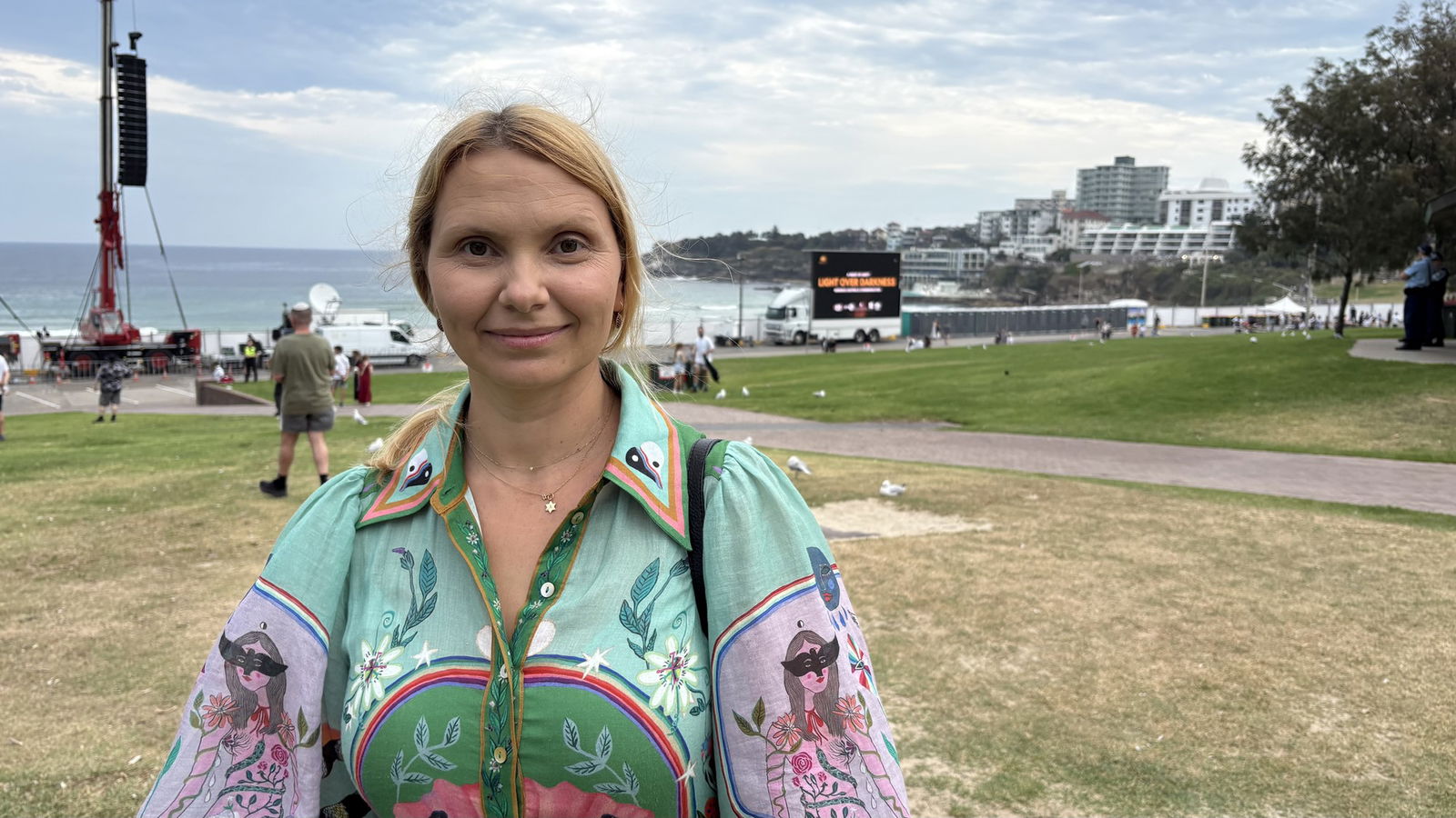 Woman smiles with Bondi Beach behind her
