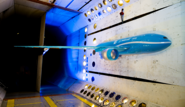 A scale model of possible future commercial jet airplane sits inside a NASA wind tunnel where the aircraft wing was tested.