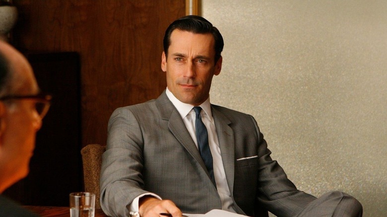 Don Draper (Jon Hamm) sits confidently looking at a client in Mad Men
