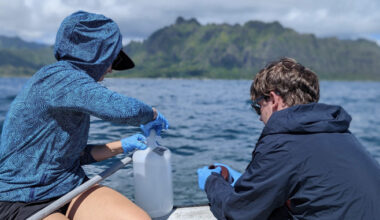 two people sampling water