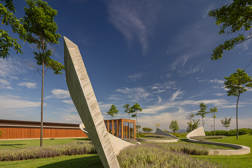 curving concrete walls encircle nest chapel’s intimate timber core in são paulo