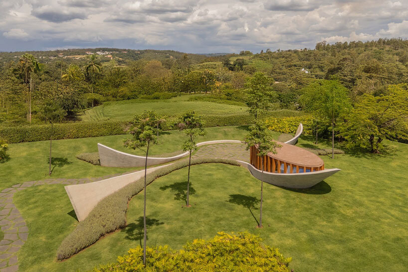 curving concrete walls encircle nest chapel’s intimate timber core in são paulo