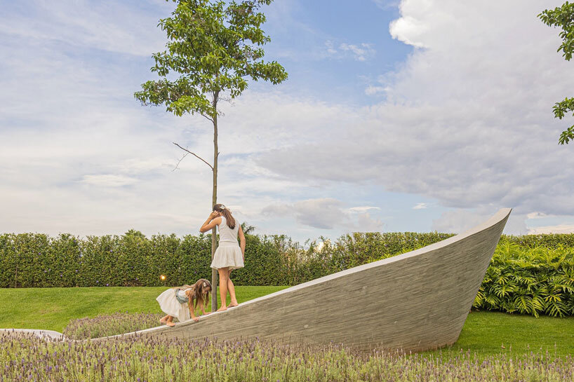 curving concrete walls encircle nest chapel’s intimate timber core in são paulo