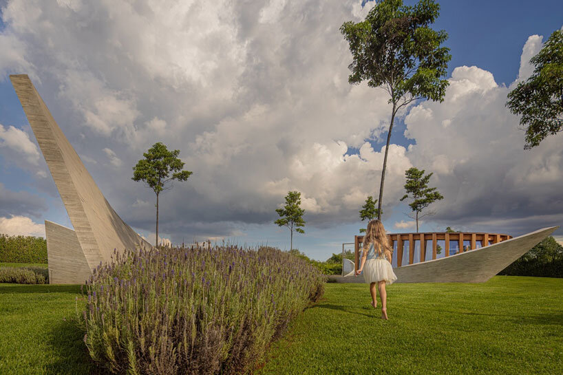 curving concrete walls encircle nest chapel’s intimate timber core in são paulo