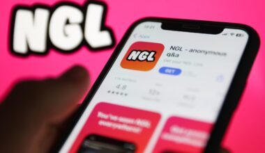 NGL on App Store displayed on a phone screen and NGL website displayed on a screen in the background are seen in this illustration photo
