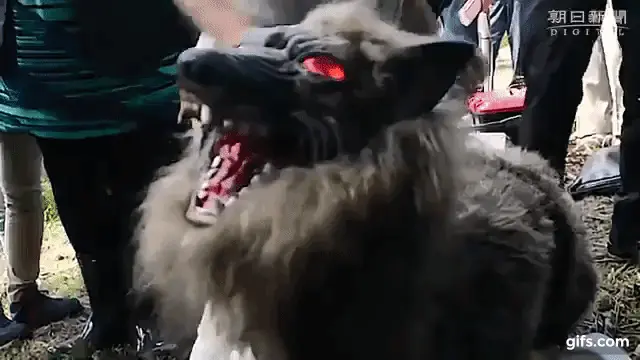 Gif of the robot monster wolf with its head turning and eyes glowing