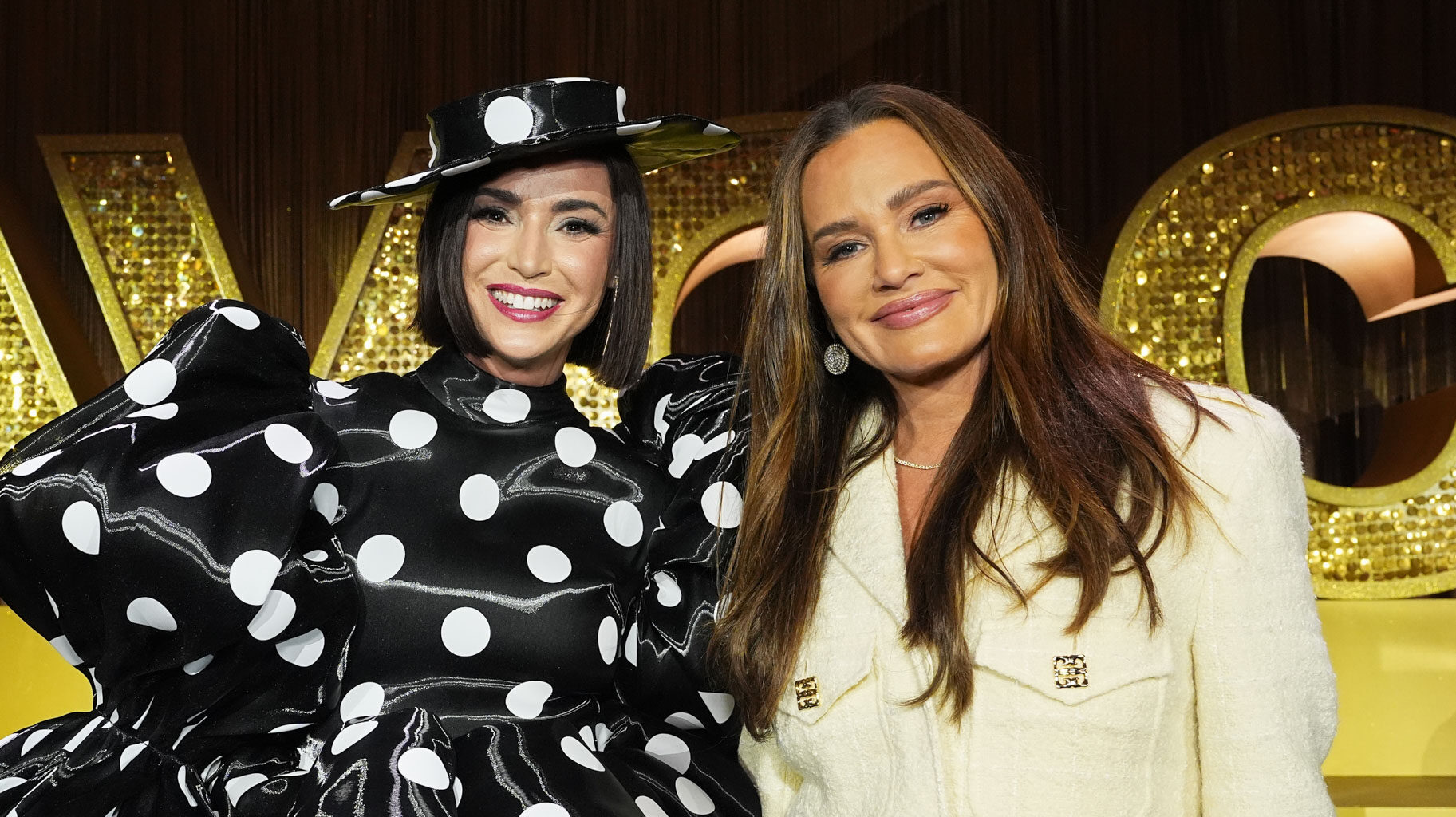 Bronwyn Newport and Meredith Marks posing together during the Spill the Salt Lake Ci-Tea panel at BravoCon 2025.