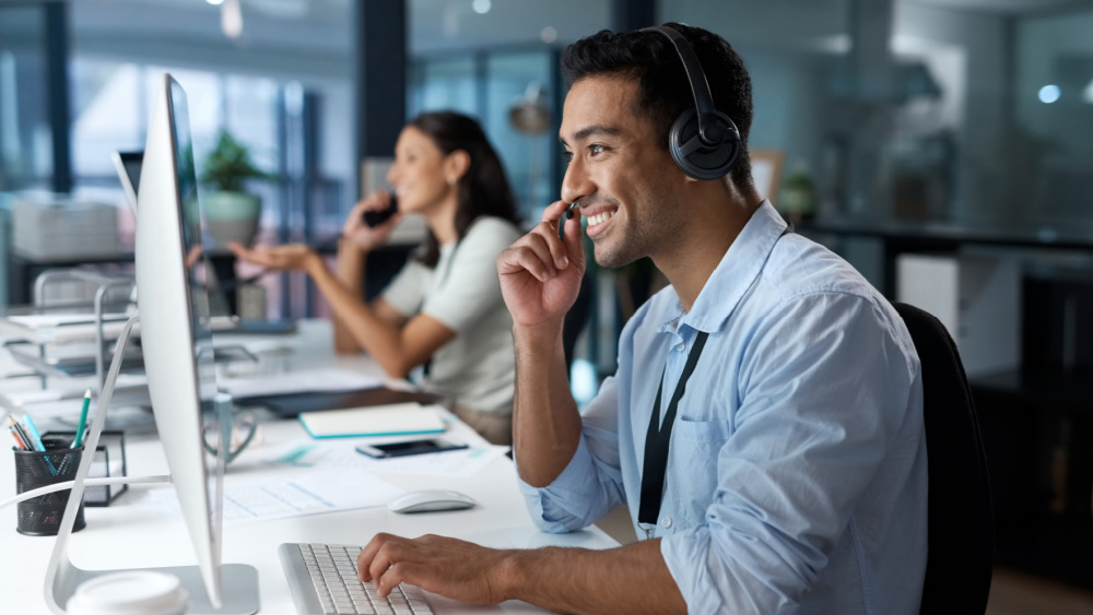 A man in front of a desktop.