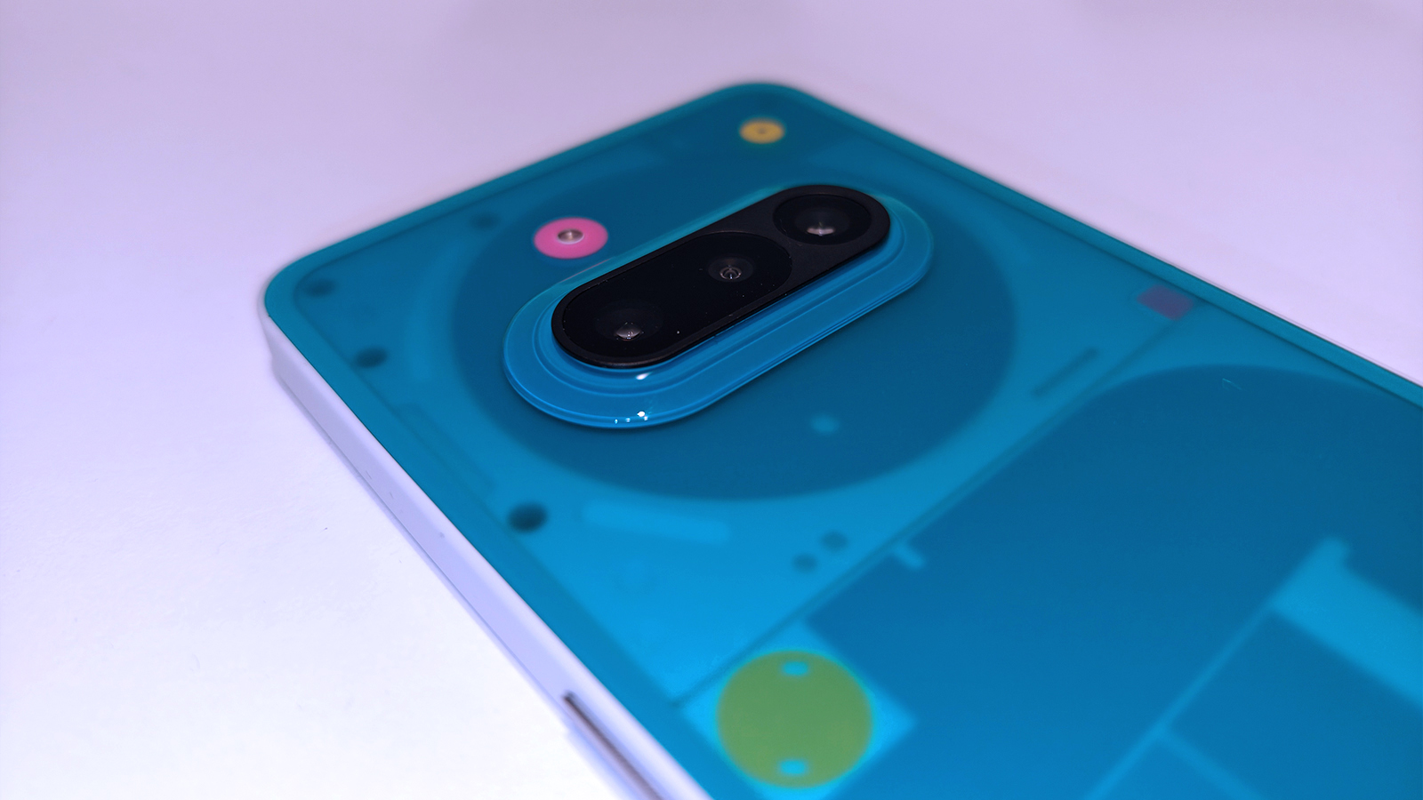 Nothing 3a Community Edition, a green phone on a white table