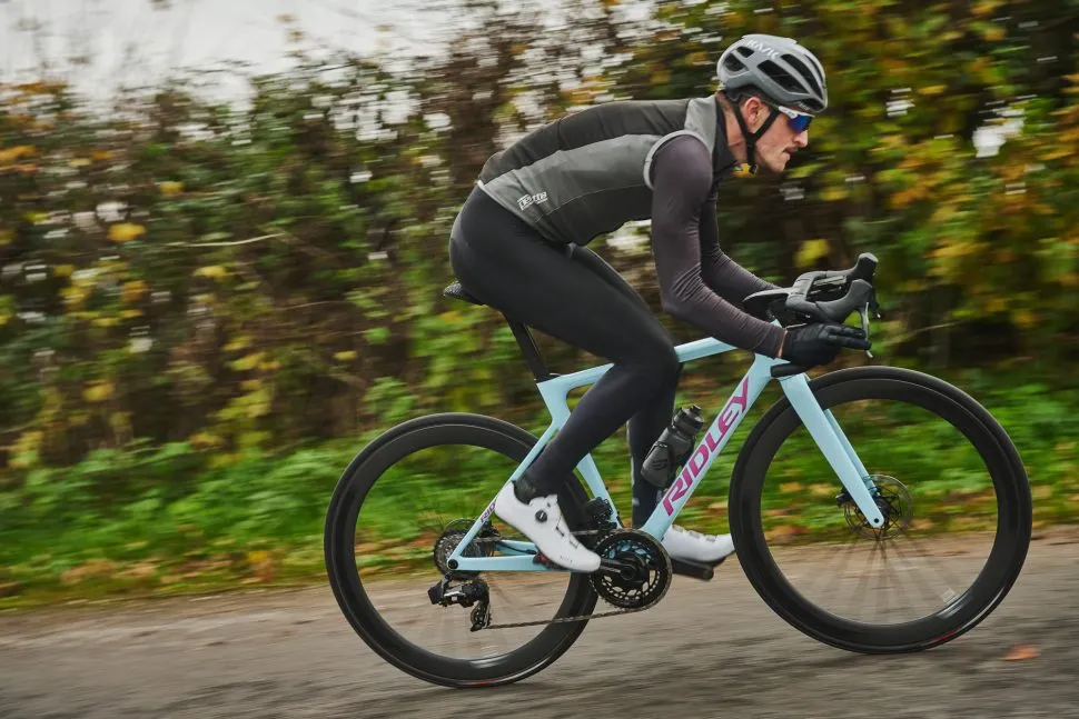 Man riding Blue Ridley Falcn RS bicycle on road
