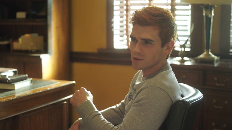 KJ Apa's Archie Andrews sitting in a chair in Riverdale