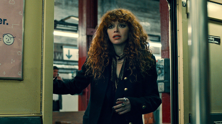 Nadia Vulvokov (Natasha Lyonne) looks concerned into a subway car on Russian Doll