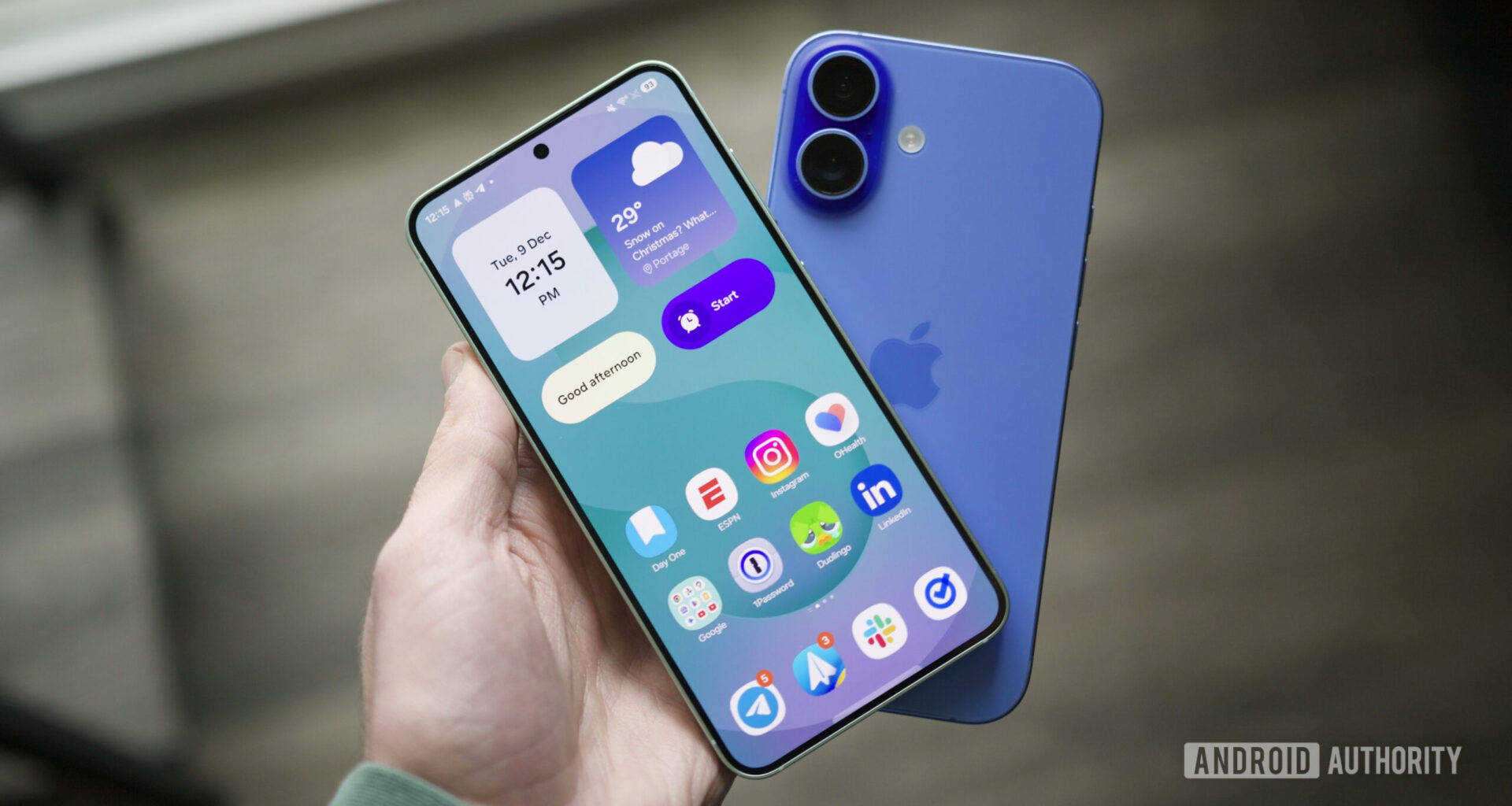 Someone holding a Galaxy S25 and an iPhone.