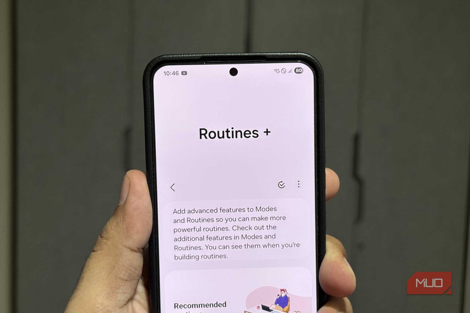 Samsung phone in hand showing Routines+ app