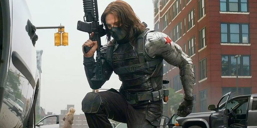 Sebastian Stan holding a gun and knelling down in Captain America: The Winter Soldier