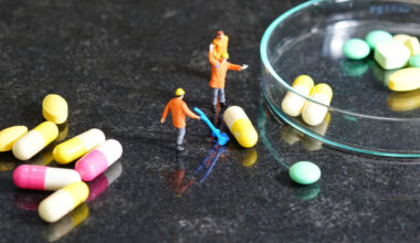 Miniature people - The worker at work with medicine pills