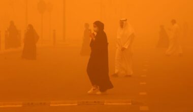 Pedestrians cross a road amidst a severe dust storm in Kuwait City on May 23, 2022.YASSER AL-ZAYYAT/AFP via Getty Images