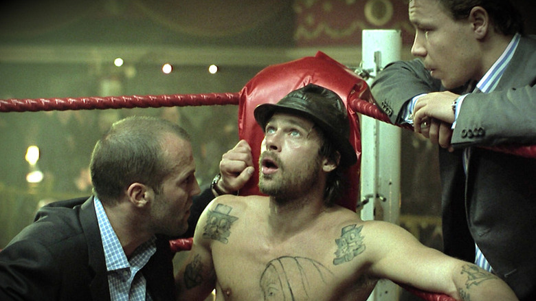 Turkish (Jason Statham) and Tommy (Stephen Graham) check on Mickey O'Neil (Brad Pitt) in a boxing ring corner in Snatch