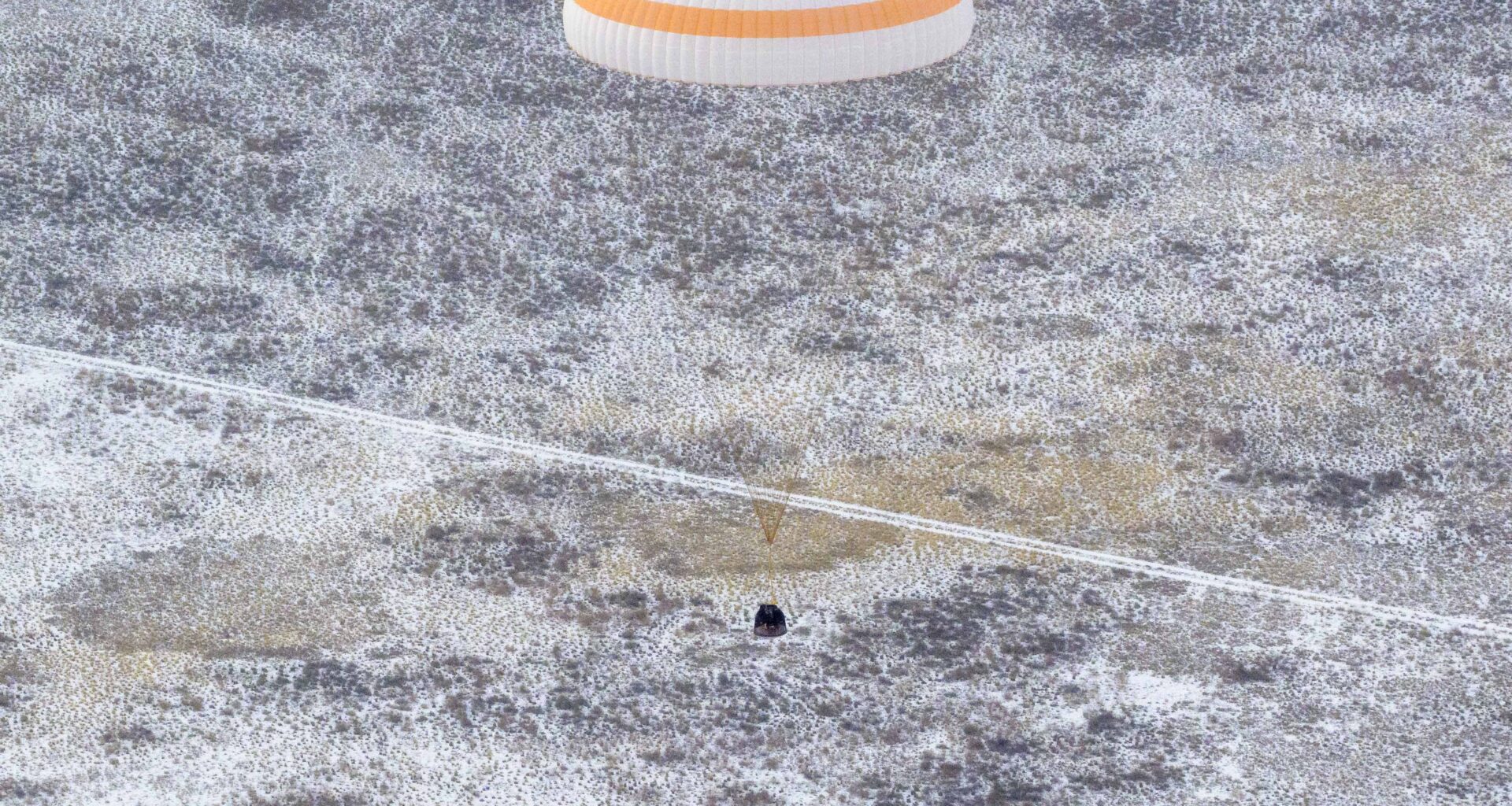 The Soyuz MS-27 spacecraft is seen as it lands in a remote area near the town of Zhezkazgan, Kazakhstan with Expedition 73 NASA astronaut Jonny Kim, and Roscosmos cosmonauts Sergey Ryzhikov, and Alexey Zubritsky aboard, Tuesday, Dec. 9, 2025. The trio are returning to Earth after logging 245 days in space as members of Expeditions 72 and 73 aboard the International Space Station.