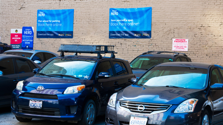 A parking lot with SpotHero ads on the back wall.