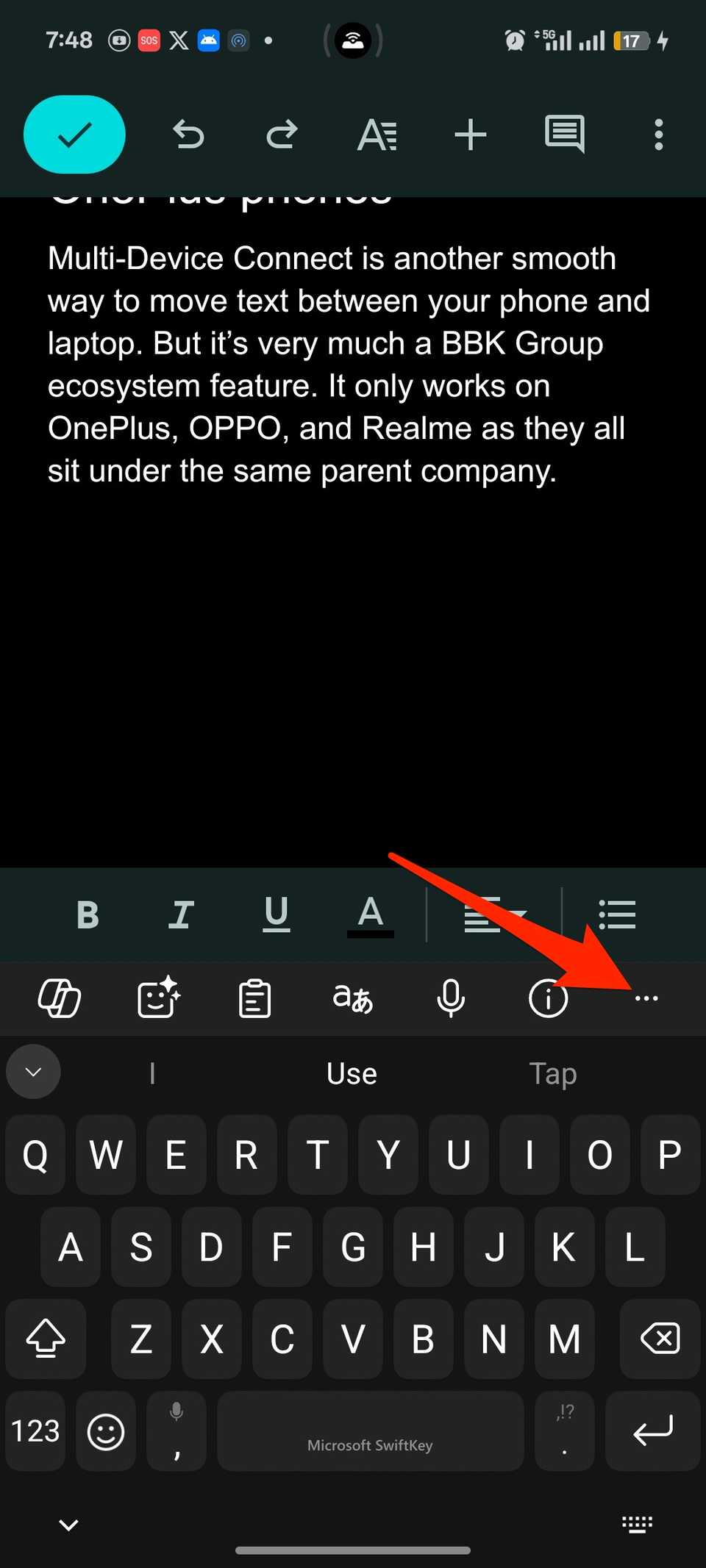 Red arrow pointing at three-dot icon on SwiftKey keyboard that is open in Google Docs