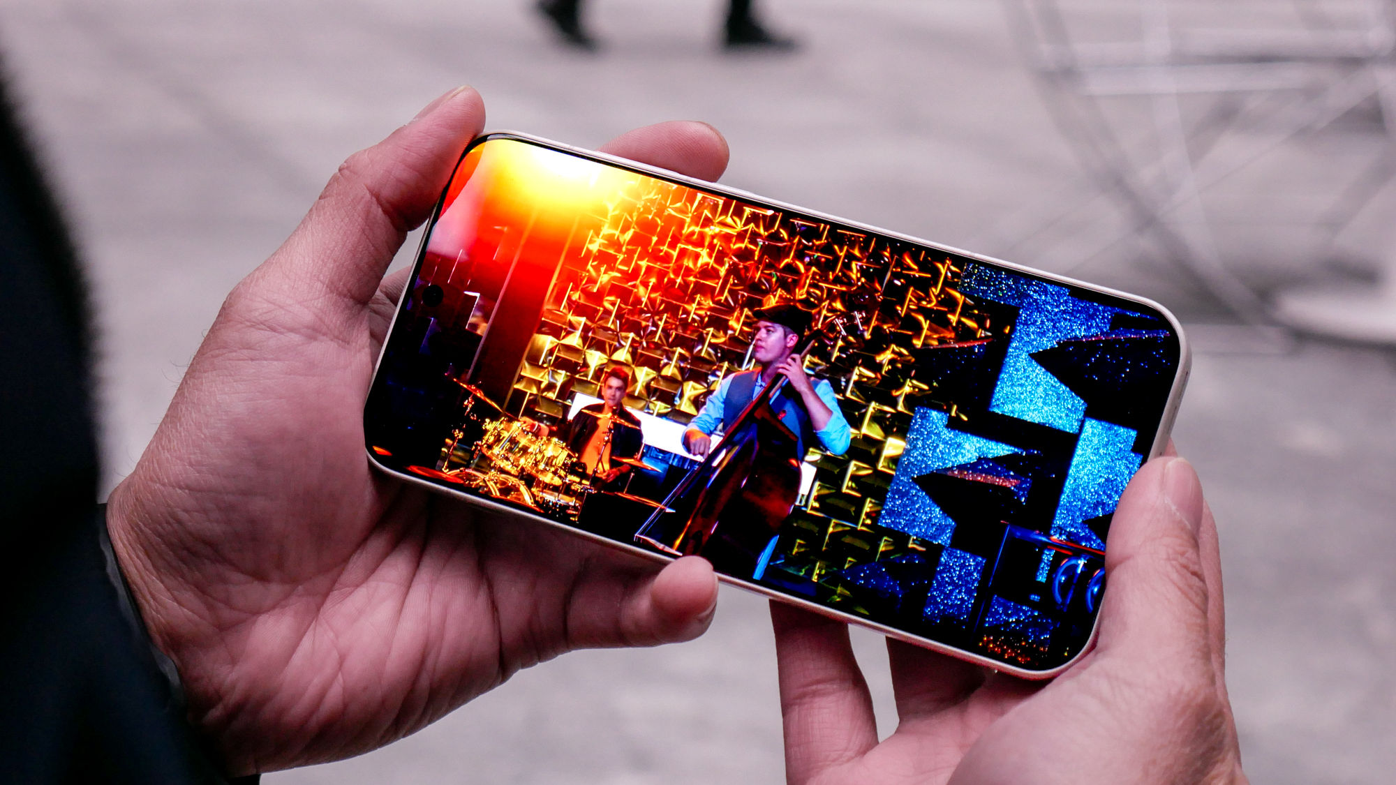 OnePlus 15 review playing a video outside.