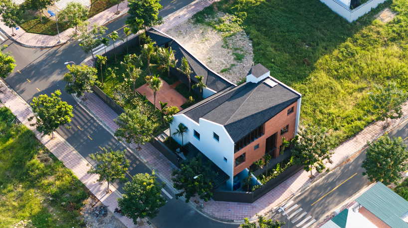 tent house expands under overlapping angular roof planes in vietnam