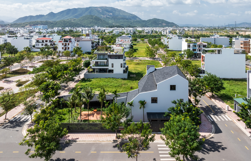tent house expands under overlapping angular roof planes in vietnam