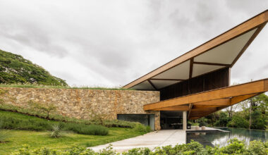 brazilian lakeside house by TETRO hides beneath triangular roof