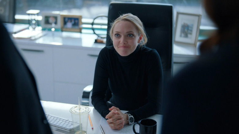 Elizabeth Holmes (Amanda Seyfried) sitting at her desk on The Dropout