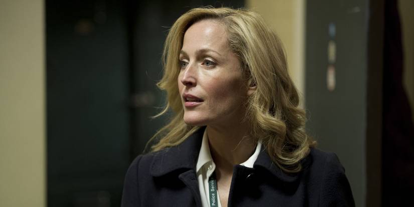 Gillian Anderson as Stella Gibson in an office hallway looking to the left in The Fall.
