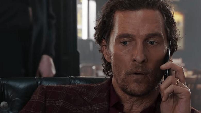 Mickey Pearson (Matthew McConaughey) listens to a cell phone in The Gentlemen