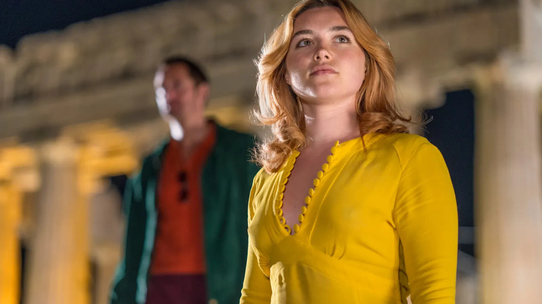 Charlie Ross (Florence Pugh) stands in front of the Parthenon with Gadi Becker (Alexander Skarsgård) in The Little Drummer Girl