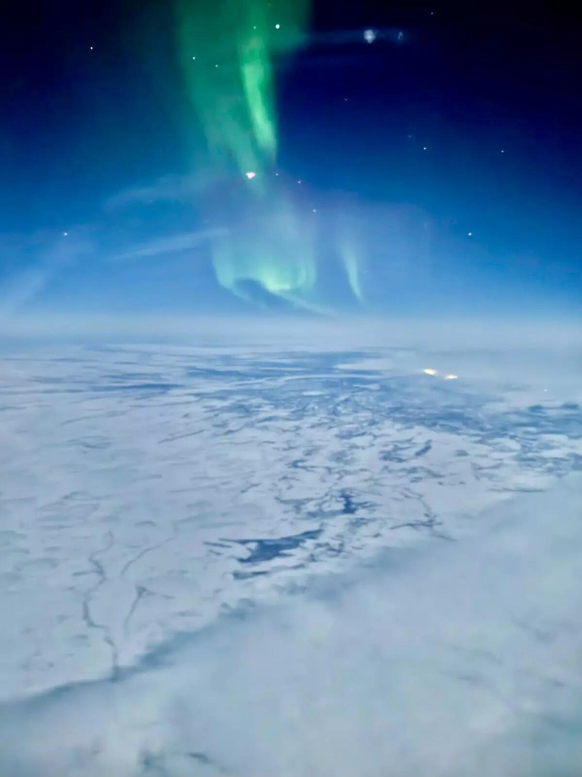 Flying over the North Pole. (Photo by Jake Chasan) These images capture the northern lights as seen from an SFO–Qatar flight.