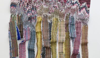 A large woven wall hanging by Kenny Nguyen made from strips of silk fabric