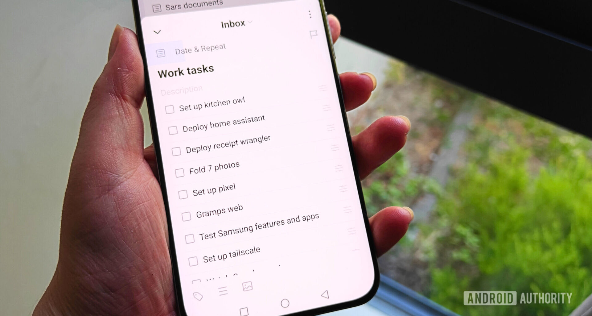 ticktick tasks on a smartphone held in a hand