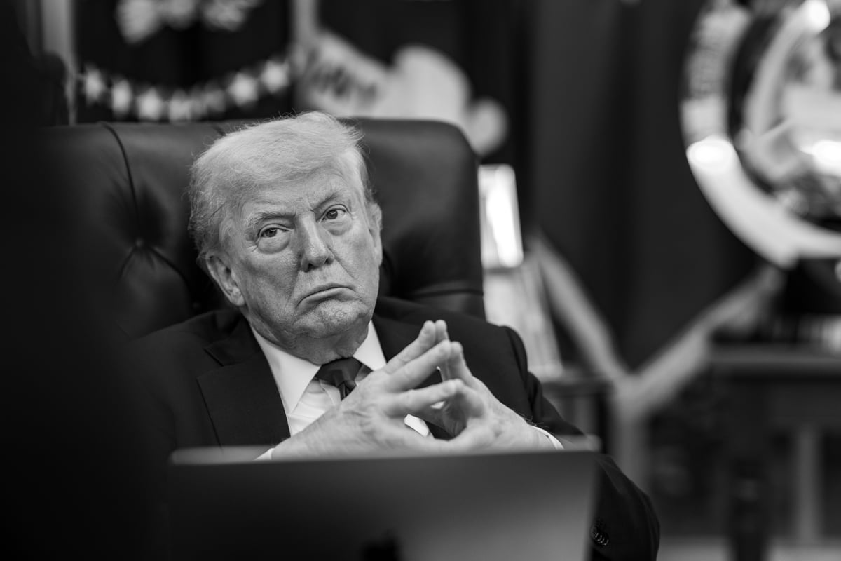Donald Trump sitting with his fingers tented during a meeting in the Oval Office.