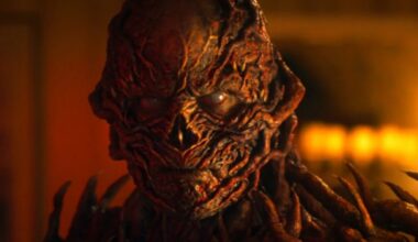 closeup of Vecna in full monster form bathed in ominous red /orange light