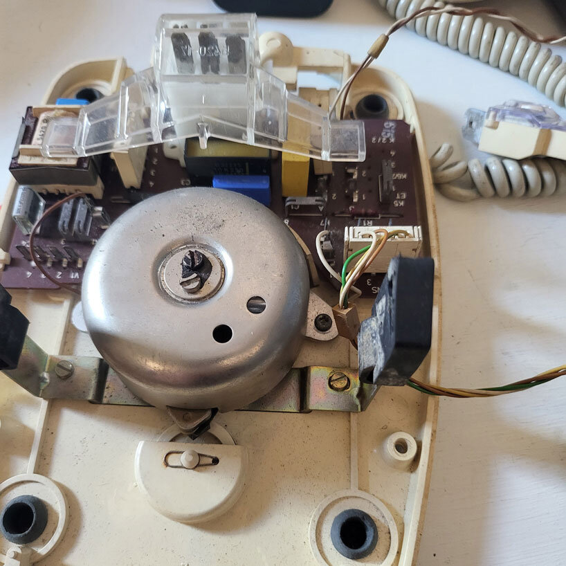 vintage rotary telephone transforms into analog-digital hybrid music player and AI voice chat
