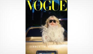 A person wearing black sunglasses and a white, feathered outfit stands in front of a gold car. The image is the cover of Vogue Portugal magazine, with large yellow text at the top and additional headlines below.