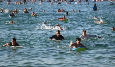 A sunrise crowd gathers at Bondi Beach in solace and defiance after a massacre