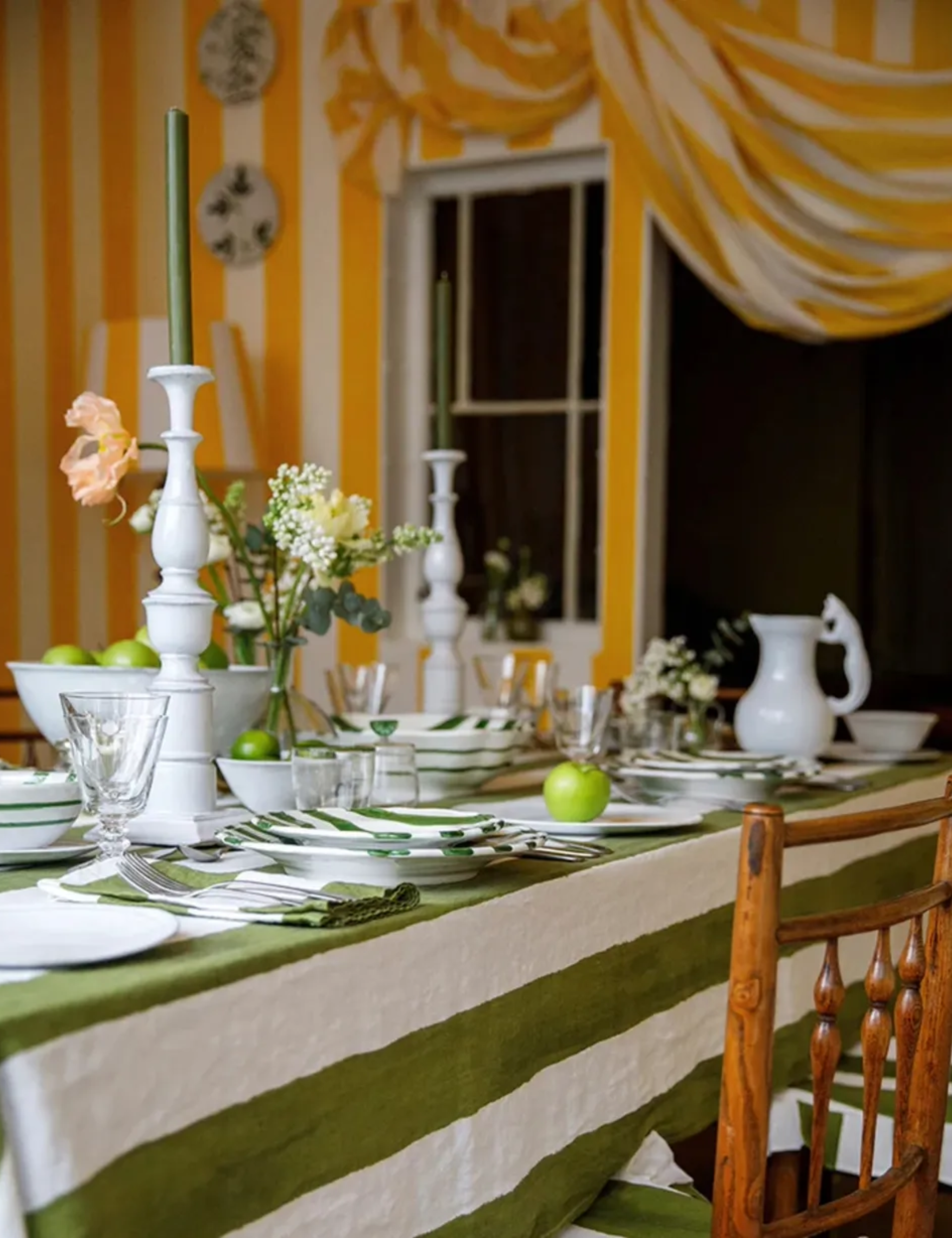 Striped green and white tablecloth in a dining room